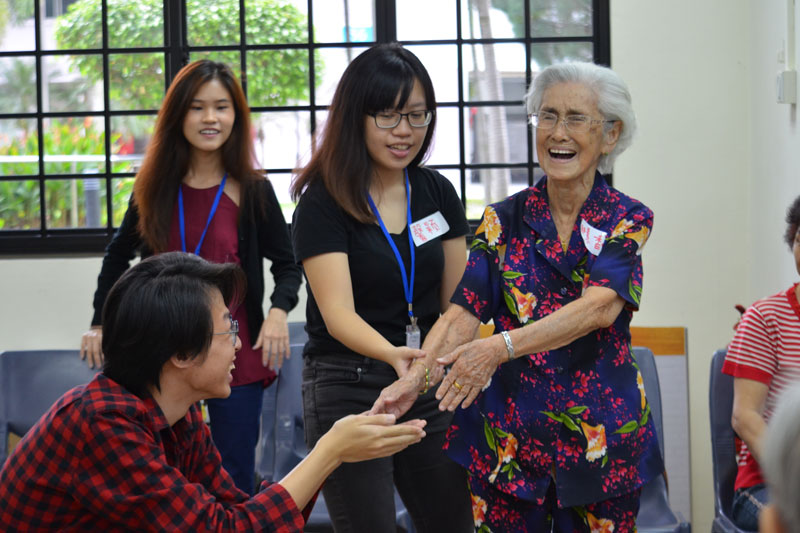 Three youth interacting with an elderly participant