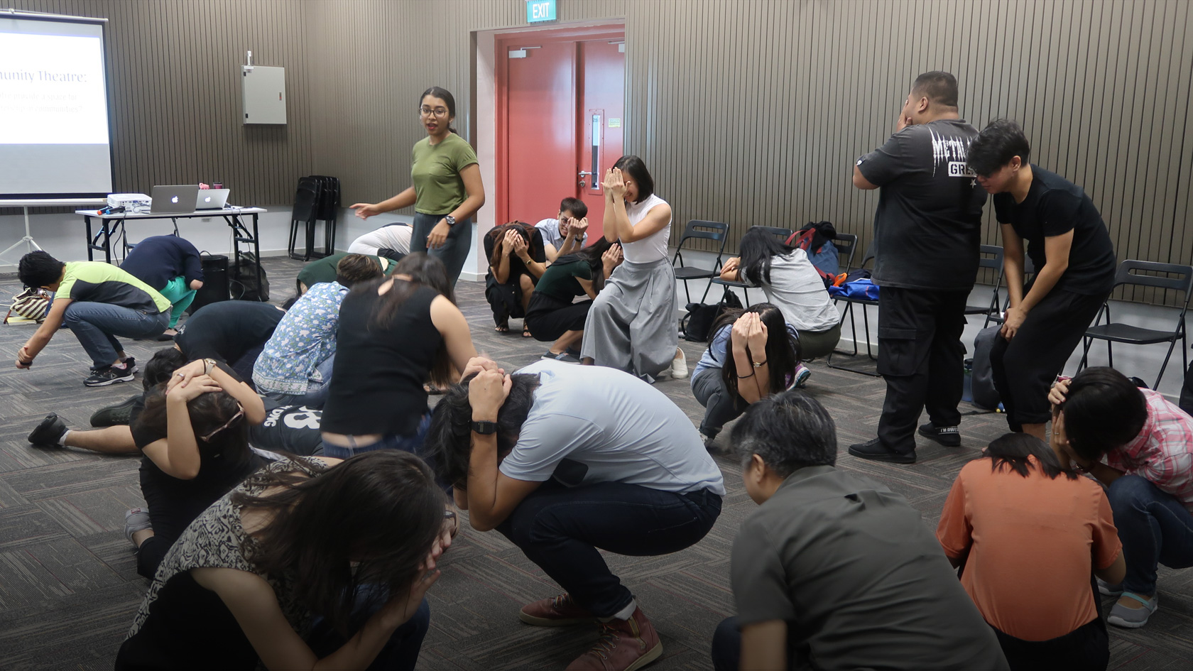 Participants crouching down during a drama activity