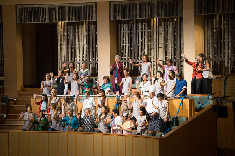 A group of people standing at the Theatre balcony and waving