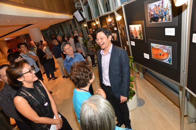 Guests looking through the photograph exhibition documenting the performance process. Photo Credit - Guek Peng Siong