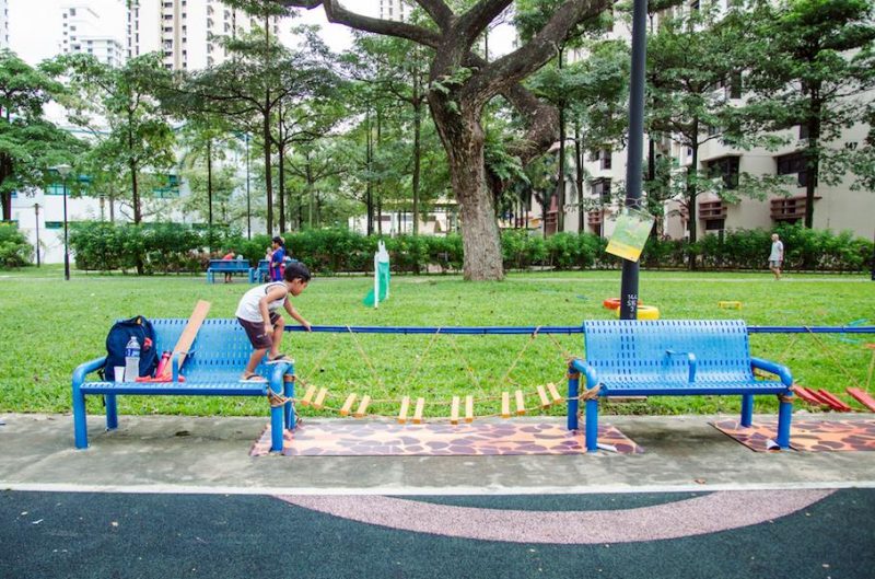 A young boy attempts to cross an obstacle course, constructed by Nanyang Polytechnic's Visual Communications students, during "Seeing the Obvious"