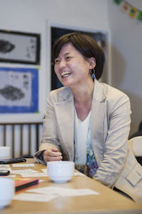 Habara Yasue smiling while seated at table
