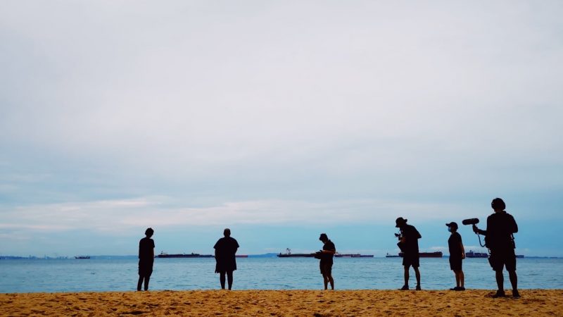 A film crew of six people by the shore at East Coast Park
