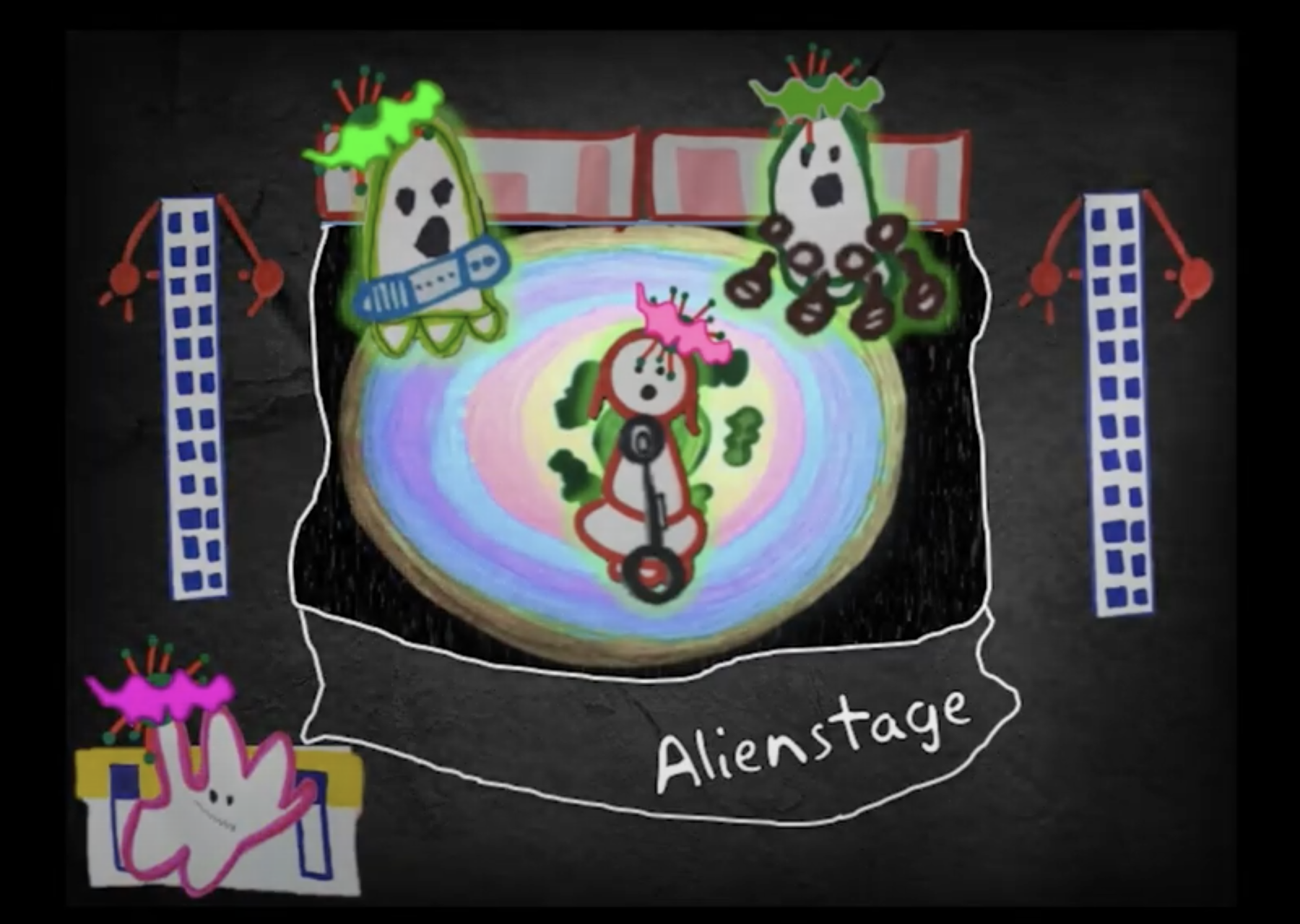 Three cartoon aliens are performing a rock concert on a colourful, pastel stage labelled Alienstage. Each alien has spikey hair which is pink or green. One alien shaped like a pink slime is playing the keyboard on the side.