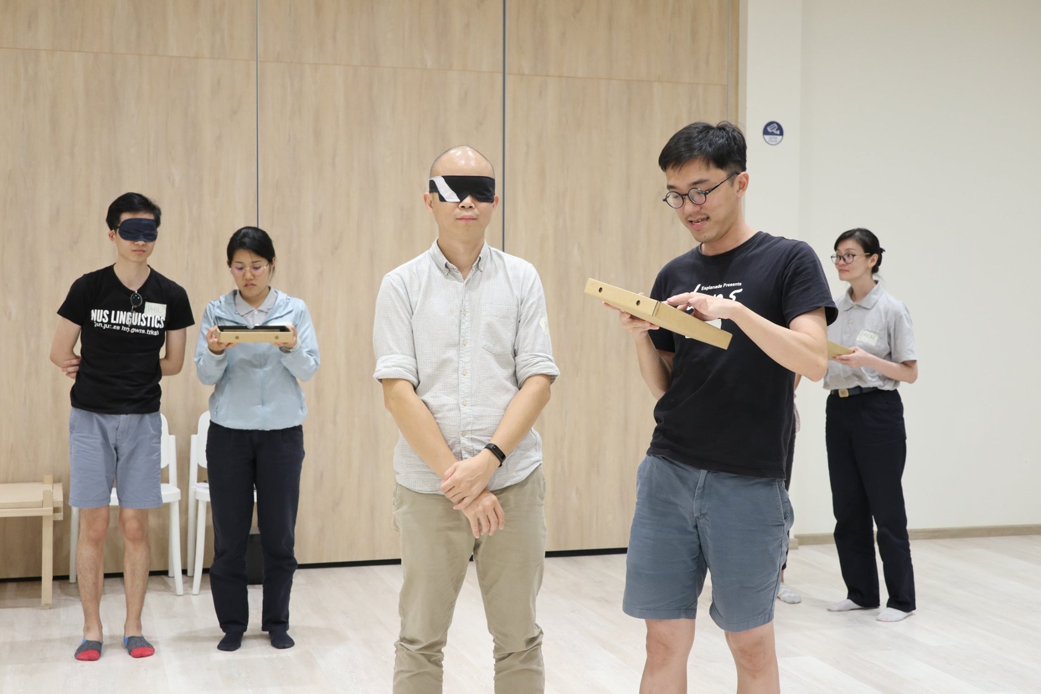 What If volunteers in pairs. One in a pair is blindfolded while the other is holding and touching a tactile board.