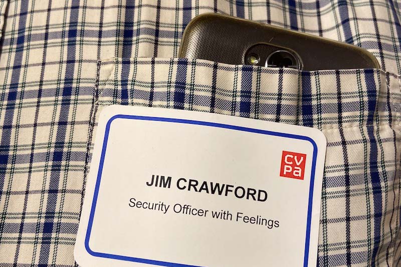Closeup photo of the nametag. The nametag reads “ JIM CRAWFORD, Security officer with Feelings”.