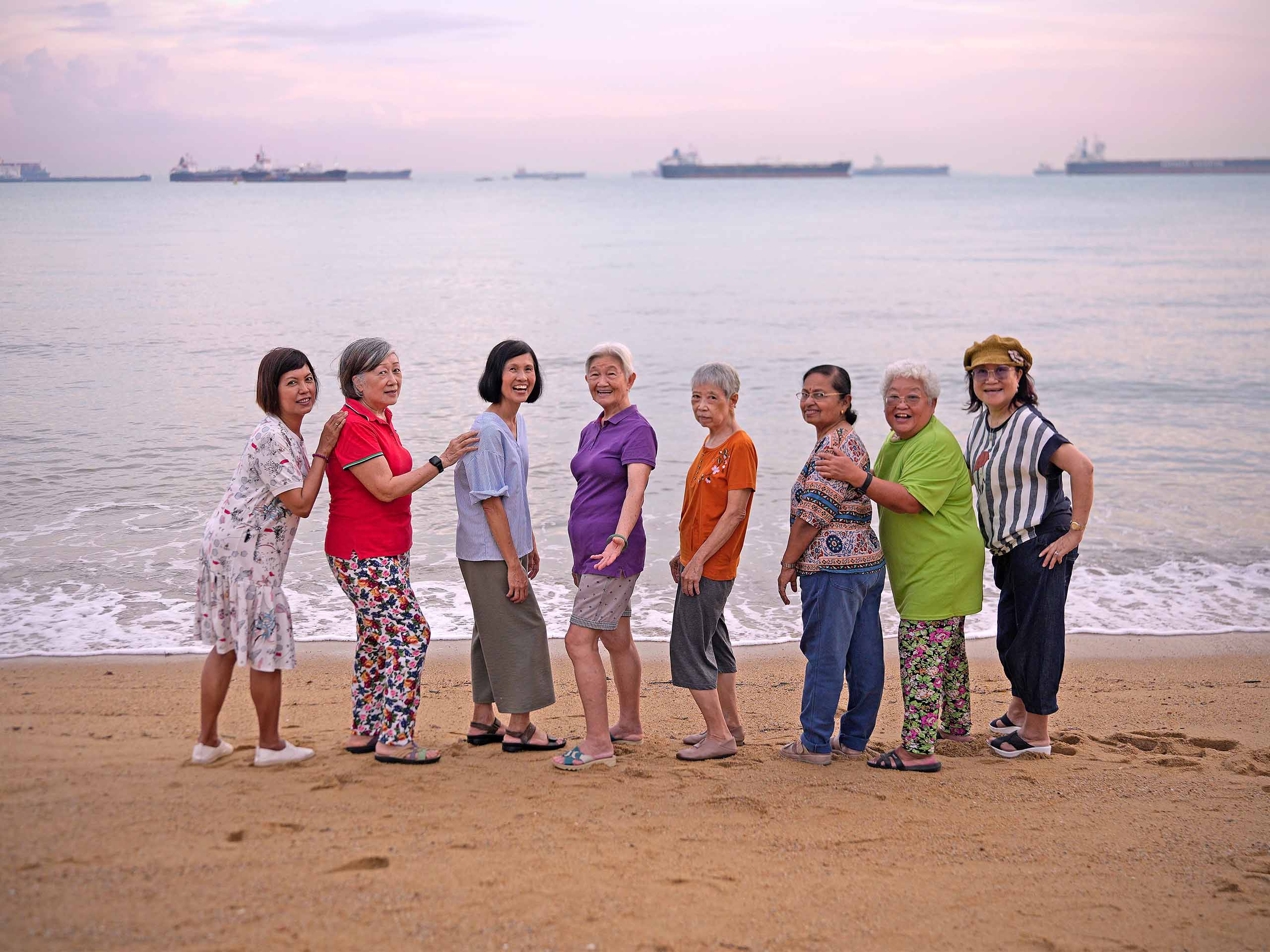 Eight senior collaborators standing on the shore.
