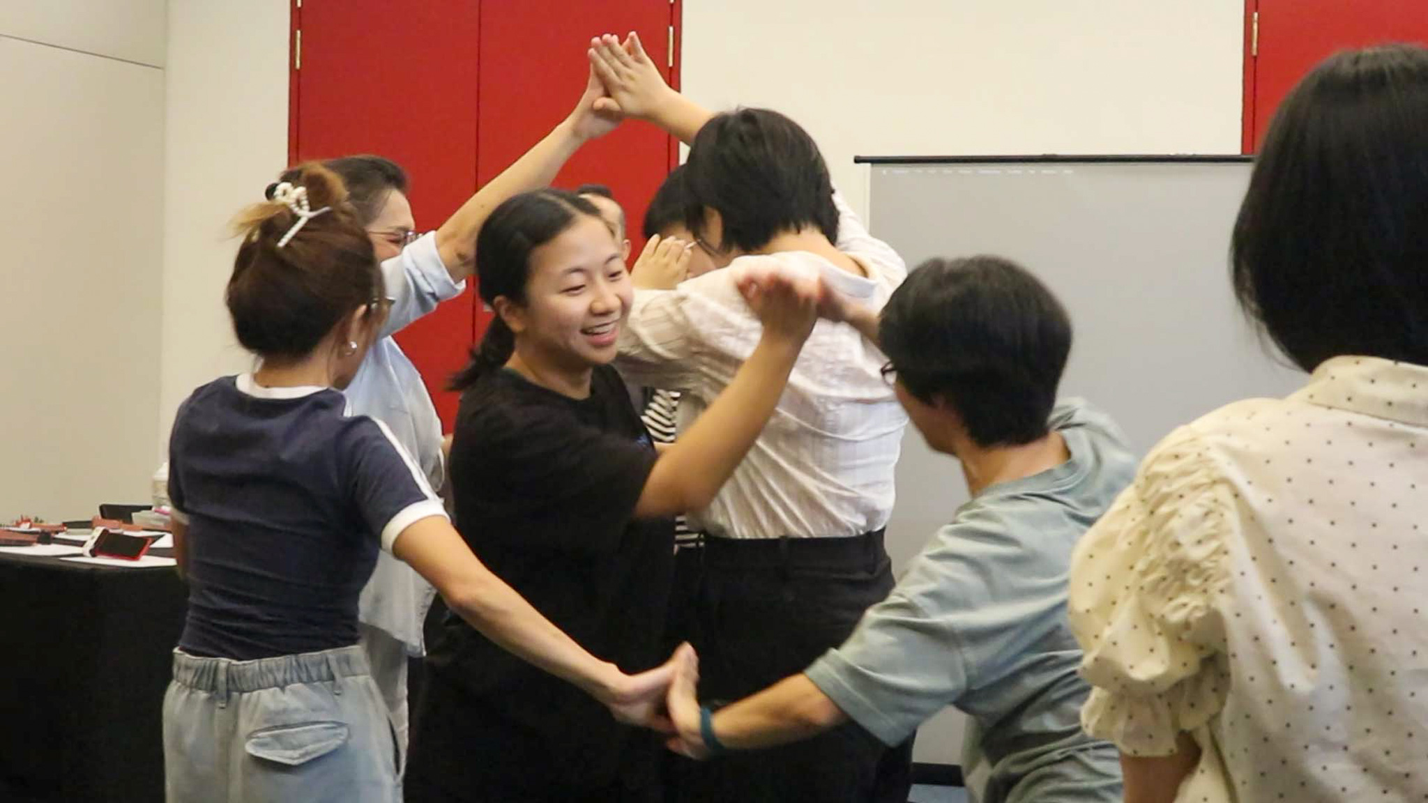 ArtsWok-Collaborative-Fundamentals-for-Arts-and-Community-Facilitators-slider-2 A facilitator commenting on a group of 5 workshop participants role play an end of life conversation scenario within a care setting
